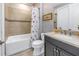 Tastefully decorated bathroom with shower-tub combination and updated vanity at 10446 Highland Park Pl, Palmetto, FL 34221