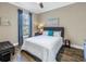 Bedroom with natural light, wood floor and an upholstered headboard at 10446 Highland Park Pl, Palmetto, FL 34221