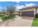 Charming home featuring paver driveway and attached garage at 10446 Highland Park Pl, Palmetto, FL 34221