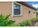 Exterior close-up showcasing home's stucco, outdoor lighting, and well-maintained landscaping at 10446 Highland Park Pl, Palmetto, FL 34221
