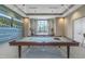 View of an entertainment room with a pool table, two televisions, and a table with chairs at 10446 Highland Park Pl, Palmetto, FL 34221