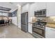 Stylish kitchen features stainless steel appliances, granite countertops, and an adjacent dining area at 10446 Highland Park Pl, Palmetto, FL 34221