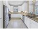Charming kitchen with white cabinets, granite counters, and stainless steel appliances at 10446 Highland Park Pl, Palmetto, FL 34221