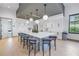 Large kitchen island with barstool seating and modern white cabinets for ample storage at 10446 Highland Park Pl, Palmetto, FL 34221