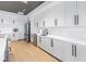 Modern kitchen with white cabinets, stainless steel appliances, light countertops, and dark hardware at 10446 Highland Park Pl, Palmetto, FL 34221