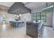 Modern kitchen area with a large island, counter seating, and sleek white cabinetry at 10446 Highland Park Pl, Palmetto, FL 34221