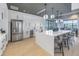 Spacious kitchen with stainless steel appliances, an island with barstool seating, and ample storage at 10446 Highland Park Pl, Palmetto, FL 34221