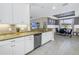Open-concept kitchen featuring stainless steel appliances, granite countertops, and seamless flow to dining area at 10446 Highland Park Pl, Palmetto, FL 34221