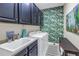 Well-appointed laundry room with sink, cabinets, and tropical wallpaper at 10446 Highland Park Pl, Palmetto, FL 34221