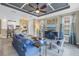 Bright living room boasts a coffered ceiling, ceiling fan and an open floor plan at 10446 Highland Park Pl, Palmetto, FL 34221