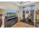 Living area with a TV, exercise bike and laminate wood flooring at 10446 Highland Park Pl, Palmetto, FL 34221