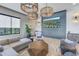 Stylish lounge area with modern furnishings, unique lighting, and a large flat screen TV at 10446 Highland Park Pl, Palmetto, FL 34221
