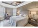 Comfortable main bedroom features tray ceiling, ceiling fan, paneled wall, and a cozy sitting area at 10446 Highland Park Pl, Palmetto, FL 34221