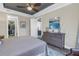 Comfortable main bedroom features a walk-in closet, dresser with art, and neutral walls at 10446 Highland Park Pl, Palmetto, FL 34221