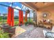 Enclosed patio featuring brick flooring, seating, and orange curtains at 10446 Highland Park Pl, Palmetto, FL 34221