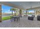 Covered patio area featuring outdoor seating with views of pool and lake at 10446 Highland Park Pl, Palmetto, FL 34221