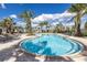 Beautiful community pool surrounded by lush tropical landscaping and comfortable lounge chairs at 10446 Highland Park Pl, Palmetto, FL 34221