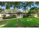 Charming single-story home featuring lush landscaping, a well-manicured lawn, and a welcoming front entrance at 1180 Eden Isle Ne Blvd, St Petersburg, FL 33704