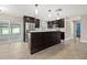 Modern kitchen with stainless steel appliances, dark wood cabinets, a bright backsplash, and access to screened patio at 1180 Eden Isle Ne Blvd, St Petersburg, FL 33704