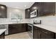 Updated kitchen featuring stainless steel appliances, quartz countertops, and modern dark cabinetry at 1180 Eden Isle Ne Blvd, St Petersburg, FL 33704