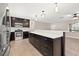 Modern kitchen featuring stainless steel appliances, bright backsplash, and a large kitchen island with quartz countertop at 1180 Eden Isle Ne Blvd, St Petersburg, FL 33704