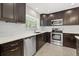 Bright kitchen showcases stainless steel appliances, white subway tile backsplash, and sleek, dark cabinetry at 1180 Eden Isle Ne Blvd, St Petersburg, FL 33704