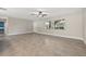 Bright living room with tile flooring and ceiling fan, large window, and view into other rooms at 1180 Eden Isle Ne Blvd, St Petersburg, FL 33704