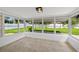Light-filled sun room featuring tile floor and large windows with a view of the yard at 1180 Eden Isle Ne Blvd, St Petersburg, FL 33704