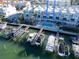 Aerial view of luxury waterfront townhomes featuring private boat docks and a community pool at 130 Brightwater Dr # 5, Clearwater Beach, FL 33767