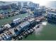 Picturesque aerial view of waterfront property with docks, and city skyline at 130 Brightwater Dr # 5, Clearwater Beach, FL 33767