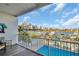 Balcony view with a waterfront pool and nearby boat docks overlooking the city skyline at 130 Brightwater Dr # 5, Clearwater Beach, FL 33767