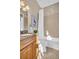 Bright bathroom with a shower-tub, vanity with granite countertop, and neutral-toned tiles at 130 Brightwater Dr # 5, Clearwater Beach, FL 33767