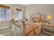 Charming bedroom with a cozy bed, two windows with blinds, and bedside tables with lamps at 130 Brightwater Dr # 5, Clearwater Beach, FL 33767