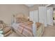Comfortable bedroom with a decorative bed, side tables, and direct access to a closet and ensuite bath at 130 Brightwater Dr # 5, Clearwater Beach, FL 33767