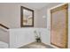 Welcoming foyer featuring wainscoting, tile flooring, an ornate mirror, and a front door with bamboo shades at 130 Brightwater Dr # 5, Clearwater Beach, FL 33767