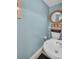 Quaint half bath featuring neutral colors, a stylish mirror, and a unique pedestal sink at 130 Brightwater Dr # 5, Clearwater Beach, FL 33767