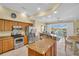 Well-equipped kitchen featuring granite countertops, stainless steel appliances, and water views at 130 Brightwater Dr # 5, Clearwater Beach, FL 33767