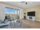 Light-filled living room with tile floors, water views, and open access to the balcony at 130 Brightwater Dr # 5, Clearwater Beach, FL 33767