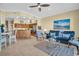 Open-concept living space featuring tile floors, comfortable furniture, and a well-equipped kitchen at 130 Brightwater Dr # 5, Clearwater Beach, FL 33767