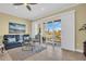 Bright living room with tile floors, a view of the water, and comfortable seating at 130 Brightwater Dr # 5, Clearwater Beach, FL 33767