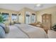 Bright main bedroom featuring water views, sitting area, and a decorative armoire at 130 Brightwater Dr # 5, Clearwater Beach, FL 33767