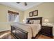 Spacious main bedroom with a large window and stylish dark wood furniture at 130 Brightwater Dr # 5, Clearwater Beach, FL 33767