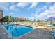 Community pool with waterfront views and lounge chairs for relaxing at 130 Brightwater Dr # 5, Clearwater Beach, FL 33767