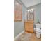 Stylish powder room with elegant wallpaper, a decorative rug, and a granite countertop at 130 Brightwater Dr # 5, Clearwater Beach, FL 33767