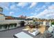 Spacious rooftop deck with a dining table, grill, lounge area, and stunning views of the cityscape at 130 Brightwater Dr # 5, Clearwater Beach, FL 33767