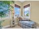 Cozy sitting area in the main bedroom with a chaise lounge, side table, and water views at 130 Brightwater Dr # 5, Clearwater Beach, FL 33767