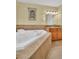 Relaxing bathroom with a jetted soaking tub, granite counters, and ample counter space at 130 Brightwater Dr # 5, Clearwater Beach, FL 33767