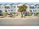 Charming multi-colored townhomes with attached garages and well-maintained landscaping offer appealing curb appeal at 130 Brightwater Dr # 5, Clearwater Beach, FL 33767