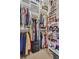 Organized walk-in closet with built-in shelving for clothes, shoes, and storage boxes at 130 Brightwater Dr # 5, Clearwater Beach, FL 33767