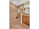 Elegant walk-in shower with tile surround and glass door, complemented by granite countertops at 130 Brightwater Dr # 5, Clearwater Beach, FL 33767
